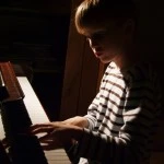 boy playing piano Will playing a musical instrument enhance memory?